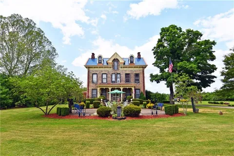 a front view of a house with garden