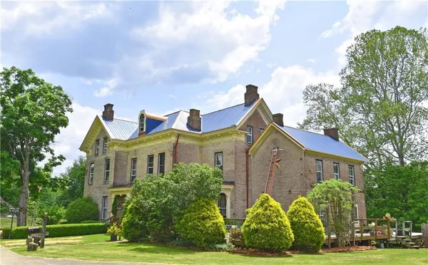 a view of yard with swimming pool and trees