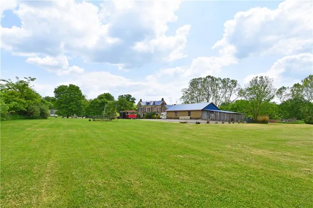 a view of a grassy field with trees