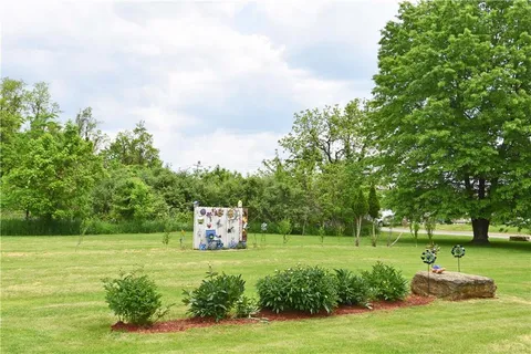 an aerial view of a house with garden space and outdoor seating