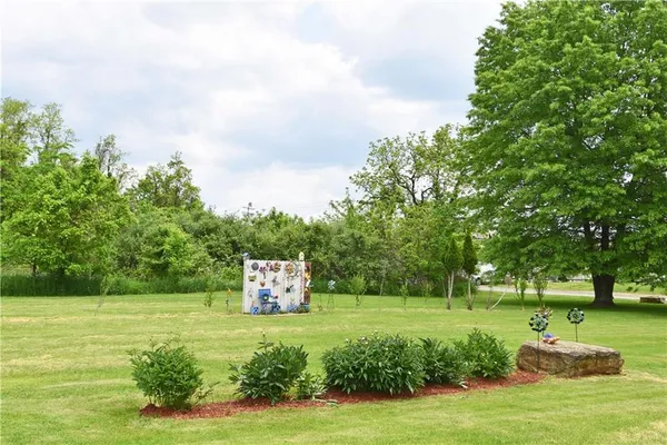 an aerial view of a house with garden space and outdoor seating