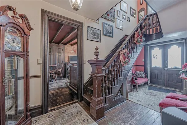a view of entryway and hall with wooden floor