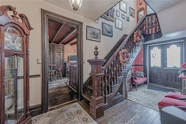 a view of entryway and hall with wooden floor