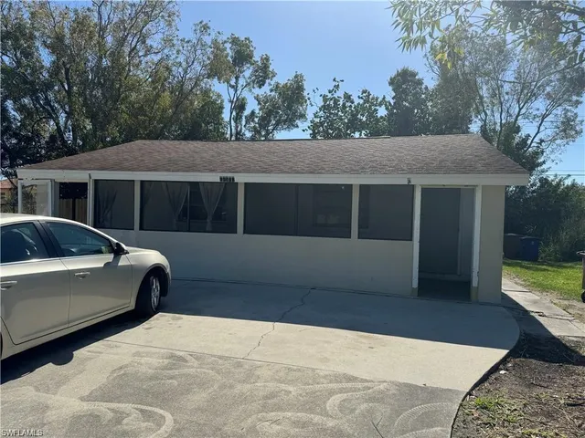 a view of a house with a yard and sitting area