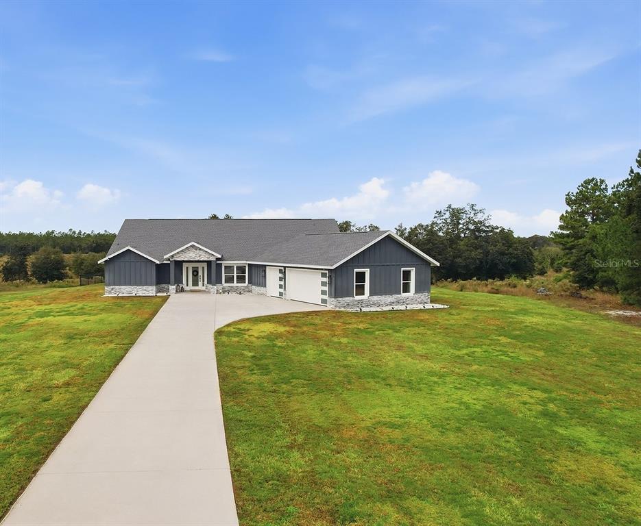 18459 Southwest 66th Loop Dunnellon, FL 34432 - Photo 2 of 41 a front view of a house with garden
