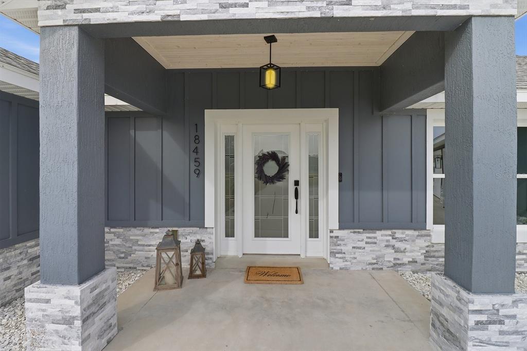 18459 Southwest 66th Loop Dunnellon, FL 34432 - Photo 3 of 41 a front view of a house with patio