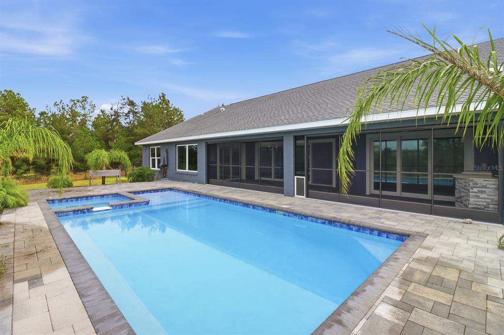 18459 Southwest 66th Loop Dunnellon, FL 34432 - Photo 33 of 41 a view of a house with swimming pool and a yard