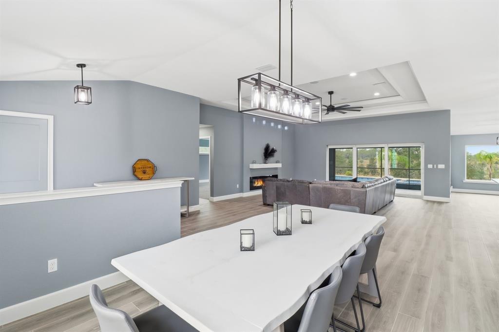18459 Southwest 66th Loop Dunnellon, FL 34432 - Photo 6 of 41 a view of a dining room and livingroom with furniture wooden floor a chandelier