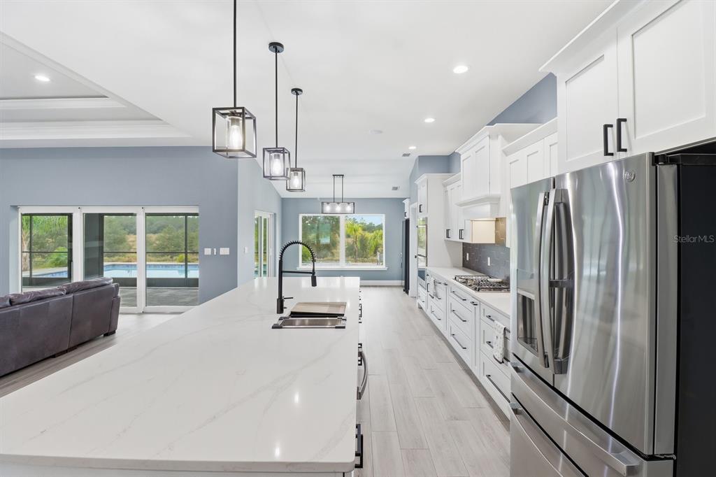 18459 Southwest 66th Loop Dunnellon, FL 34432 - Photo 10 of 41 a kitchen with stainless steel appliances a refrigerator a sink a stove and a refrigerator