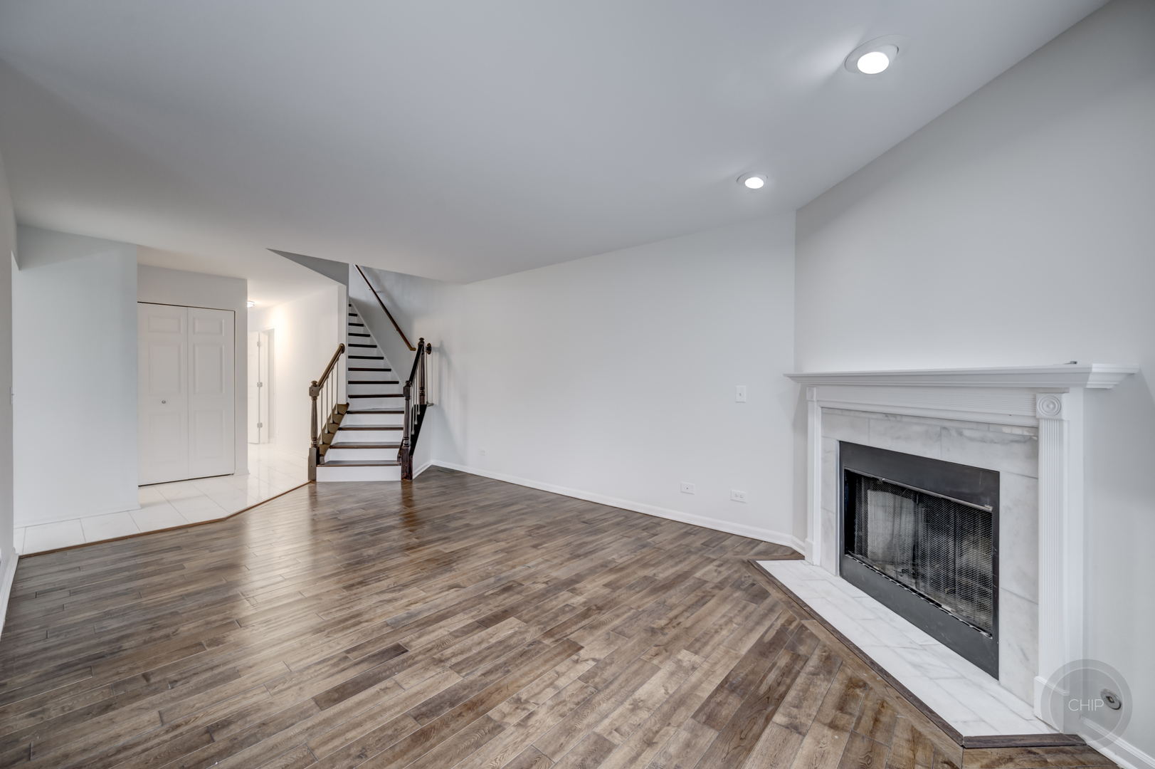 407 Inner Cir Drive Bolingbrook, IL 60490 - Photo 4 of 20 a view of an empty room with wooden floor fireplace and a window