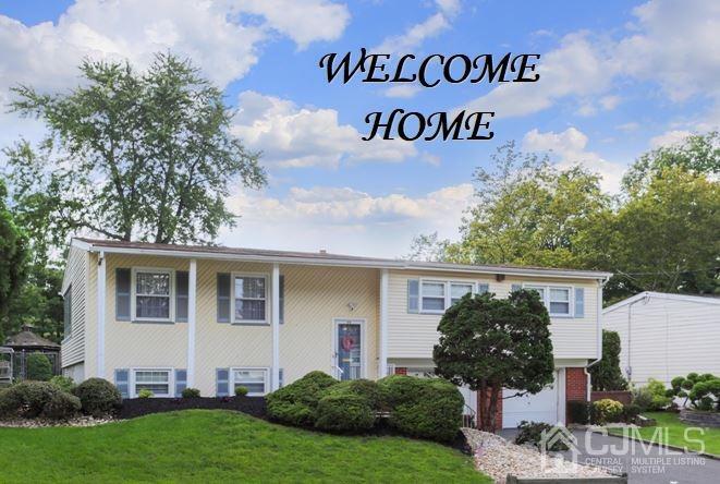 17 Peake Road Edison, NJ 08837 - Photo 1 of 18 a front view of a house with garden