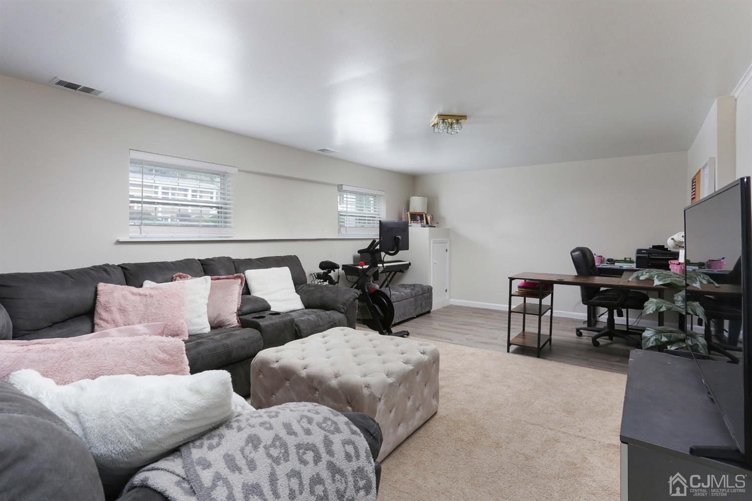 17 Peake Road Edison, NJ 08837 - Photo 14 of 18 a living room with furniture potted plant and a window