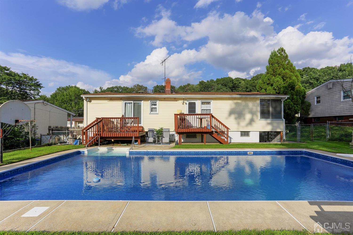 17 Peake Road Edison, NJ 08837 - Photo 16 of 18 swimming pool with trees in the background