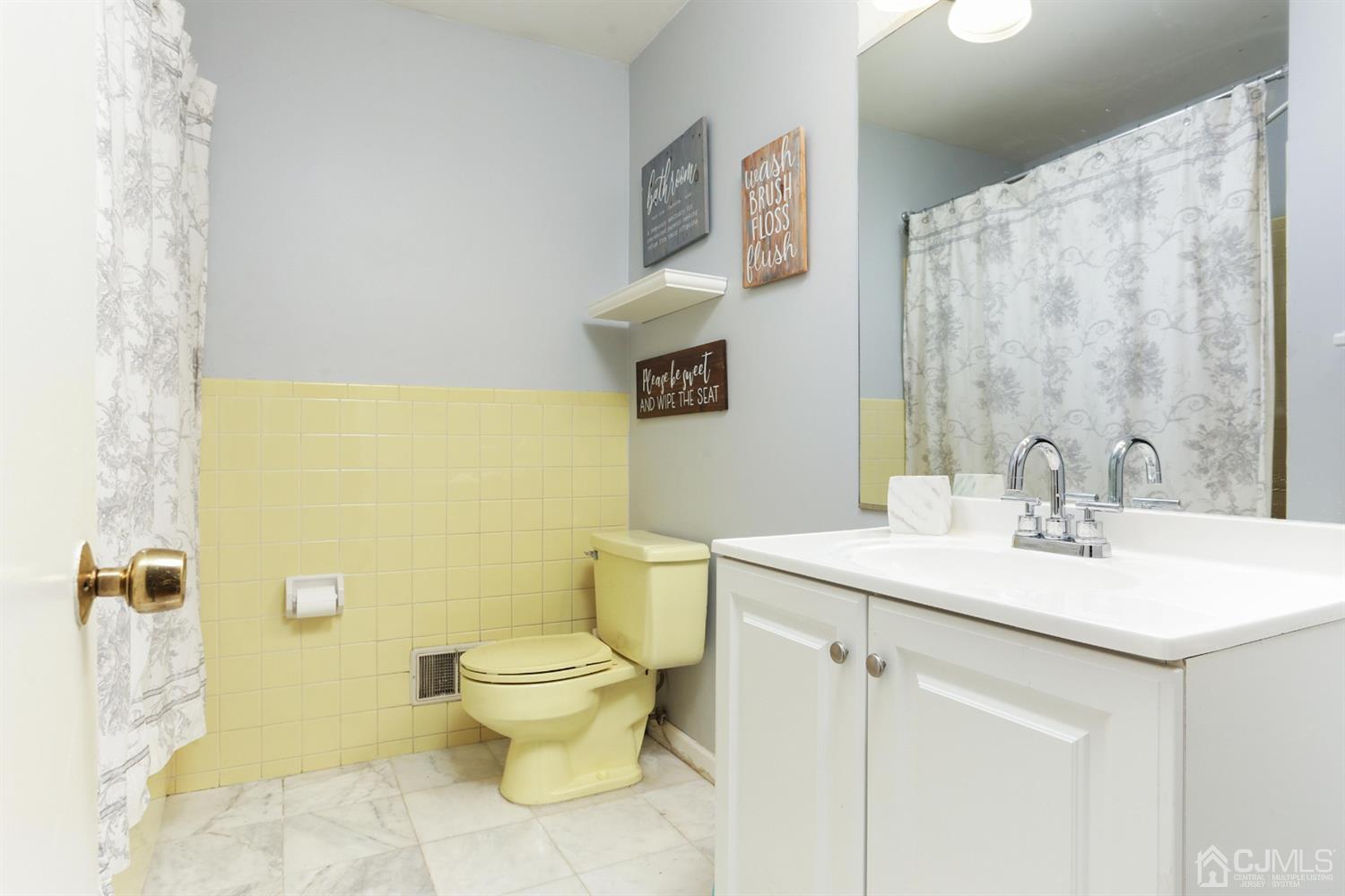 17 Peake Road Edison, NJ 08837 - Photo 9 of 18 a bathroom with a sink mirror vanity and toilet