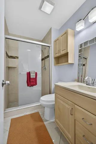 a bedroom with a large bed and a painting on the wall