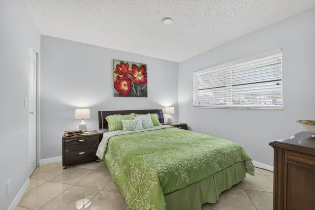 a bathroom with a sink a mirror a toilet and shower