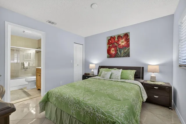a bathroom with a double vanity sink toilet mirror and bathtub