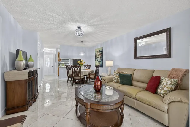 a living room with furniture and a floor to ceiling window