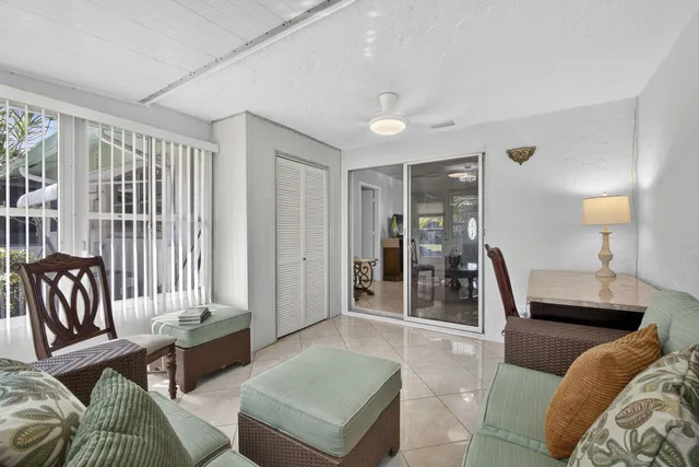 a view of a porch with furniture and floor to ceiling window