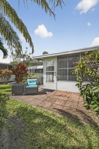 a view of a backyard with sitting area