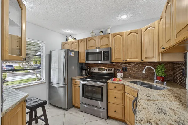 a kitchen with stainless steel appliances a stove a sink and a refrigerator
