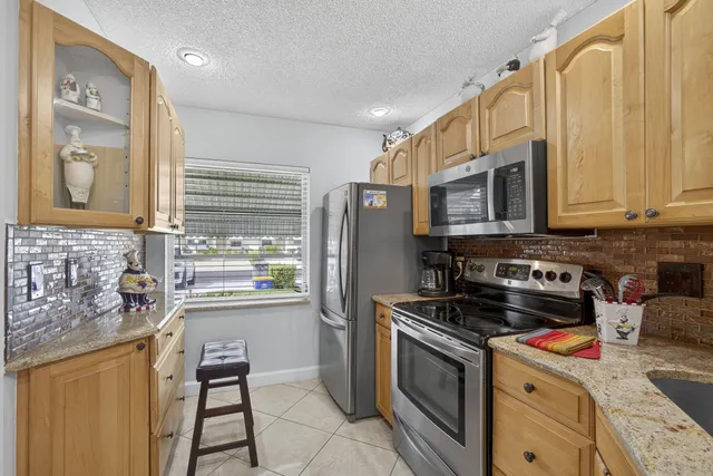 a kitchen with stainless steel appliances granite countertop a stove and a sink