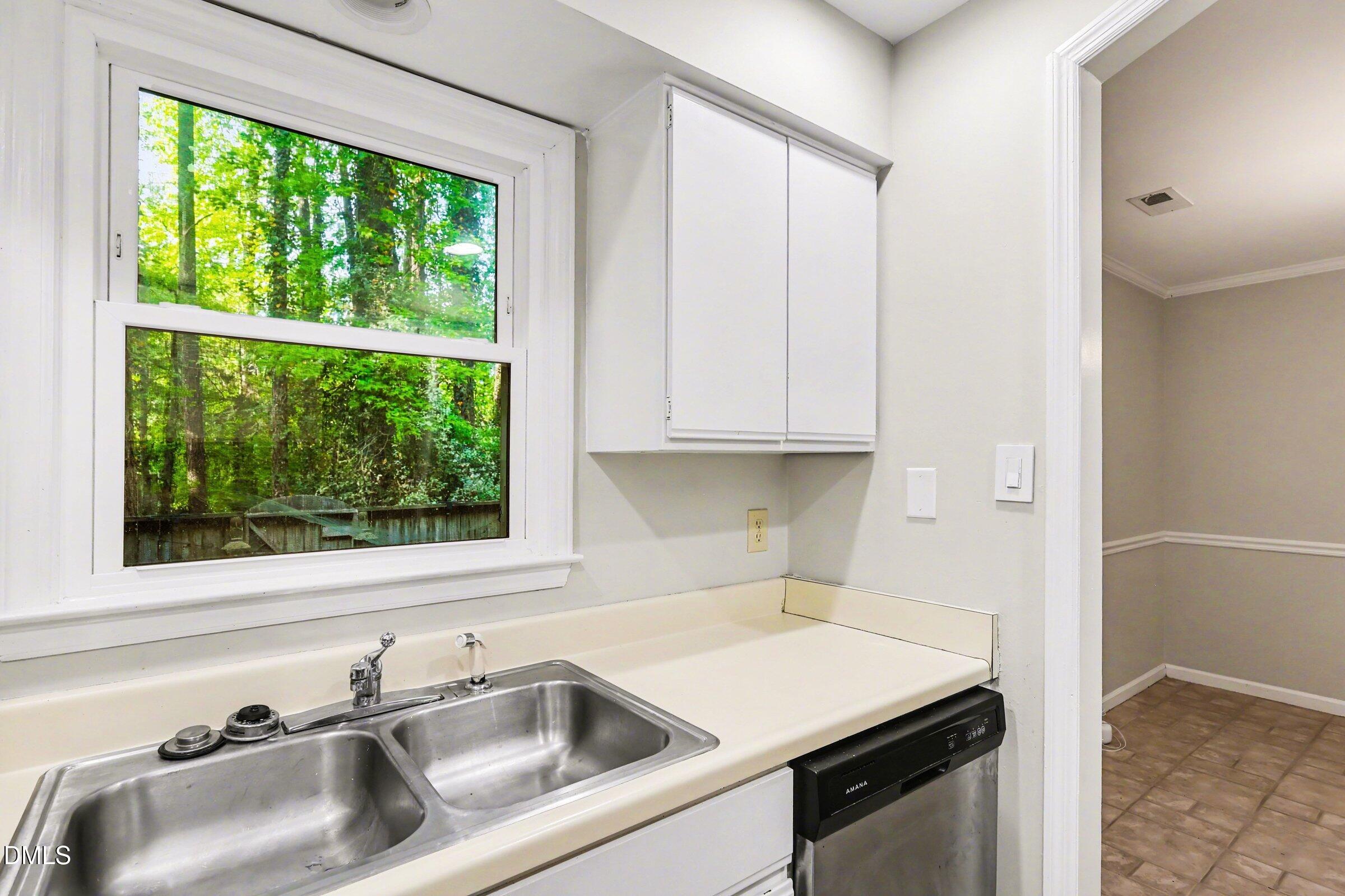 5645 Hamstead Crossing Raleigh, NC 27612 - Photo 12 of 35 a kitchen with a sink and cabinets