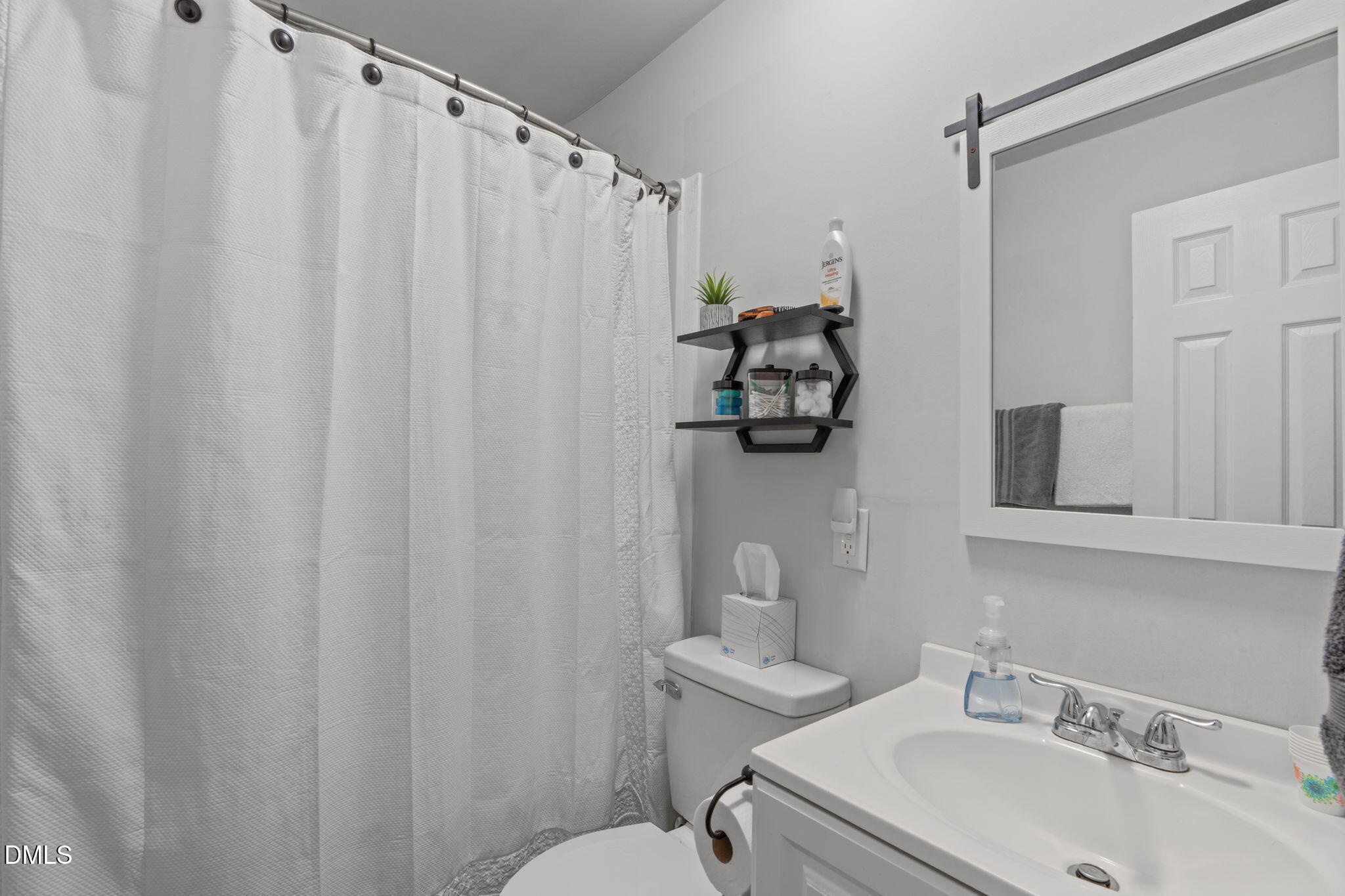 995 Shawtown Road Lillington, NC 27546 - Photo 15 of 27 Vanity and mirror with storage, tub/shower combo.