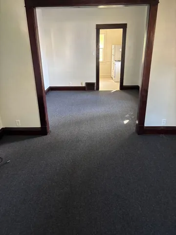 a view of an empty room and wooden floor
