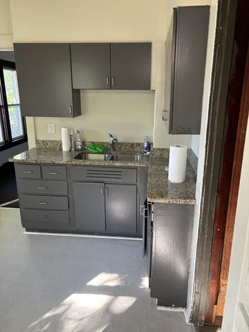 a kitchen with stainless steel appliances granite countertop a sink