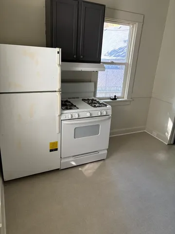 a kitchen with a stove and a refrigerator