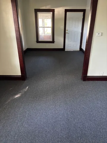 a view of an empty room and a window