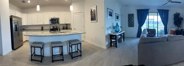 a kitchen with sink cabinets and living room