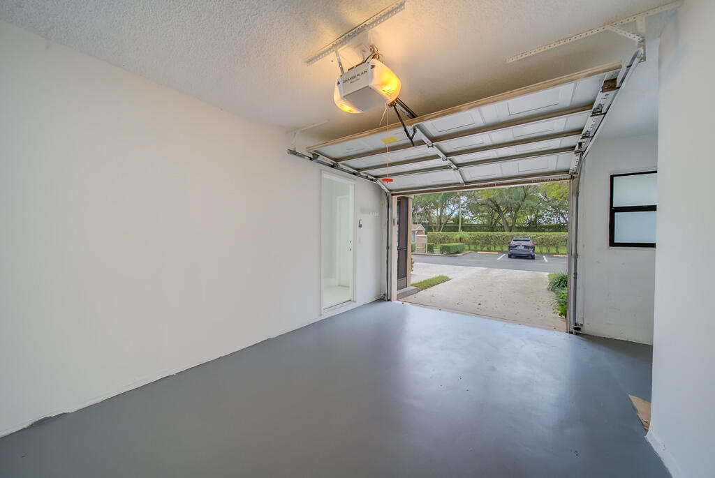 8067 Summerbreeze Lane Boca Raton, FL 33496 - Photo 23 of 29 en empty room with wooden floor and windows