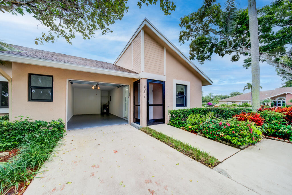 8067 Summerbreeze Lane Boca Raton, FL 33496 - Photo 25 of 29 a view of a house with a yard and potted plants
