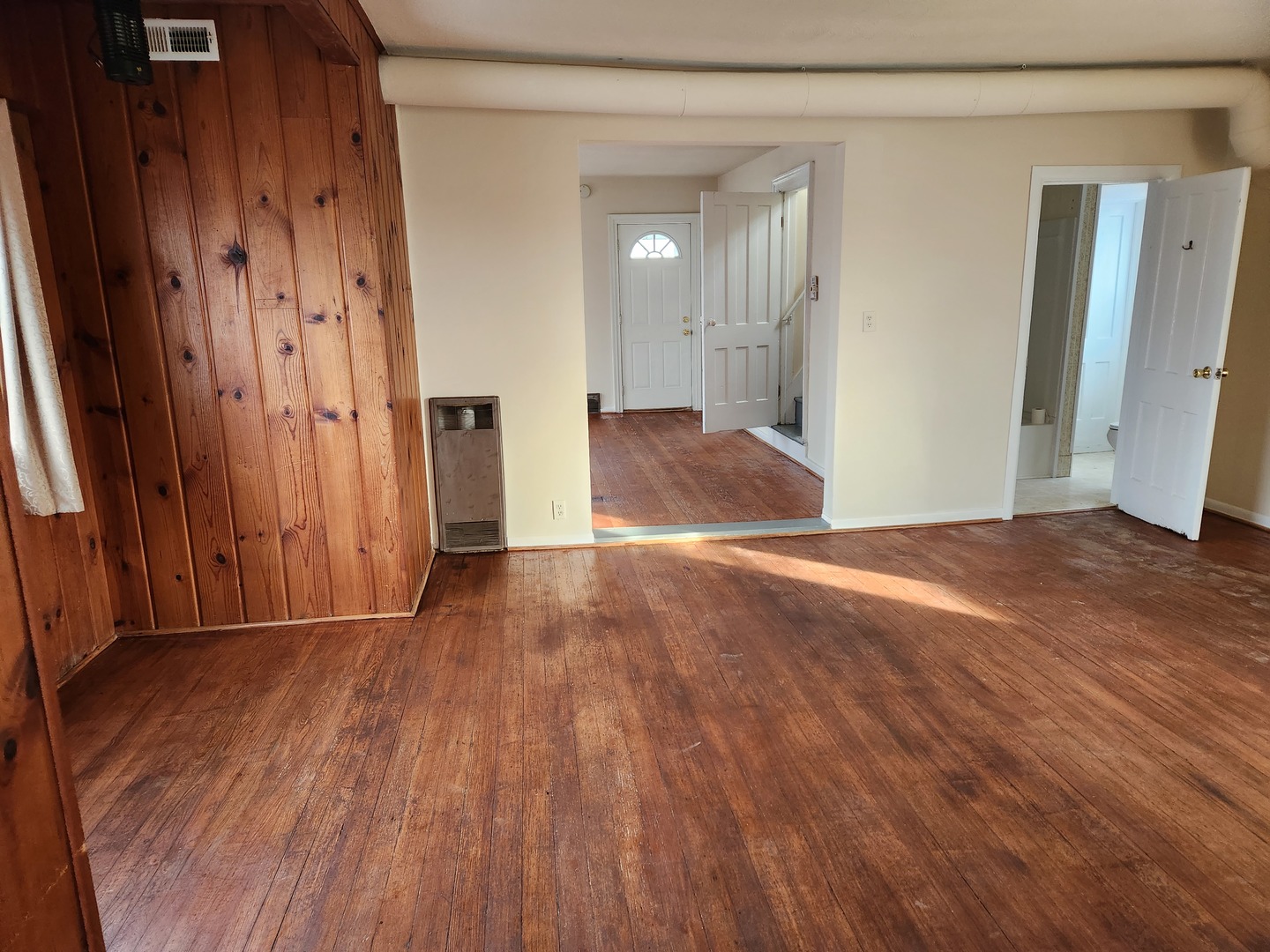 23909 Lawrence Road Harvard, IL 60033 - Photo 14 of 21 a view of a hallway with wooden floor and a bathroom