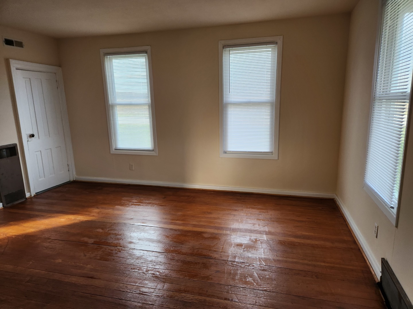 23909 Lawrence Road Harvard, IL 60033 - Photo 16 of 21 an empty room with wooden floor and windows