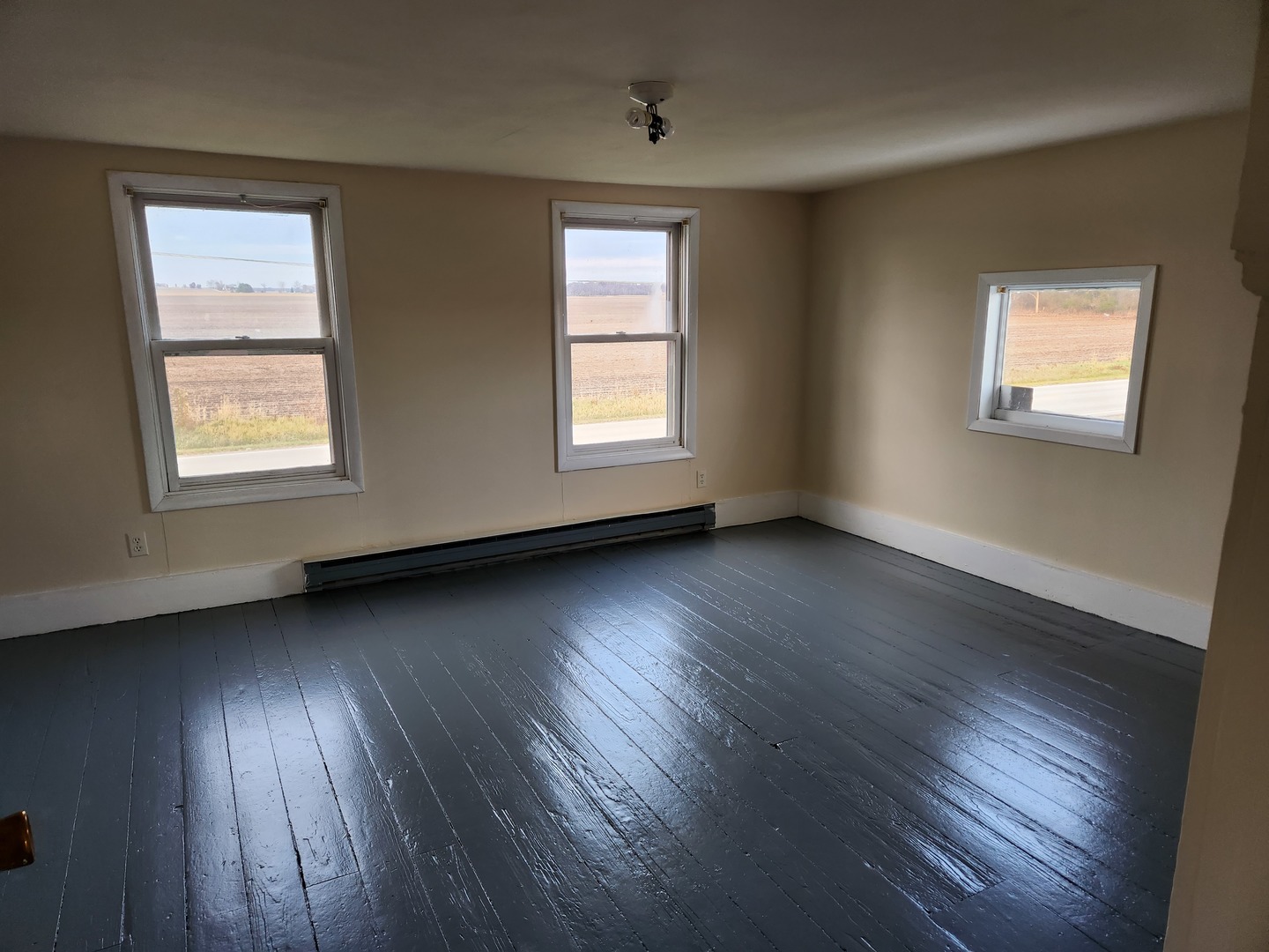 23909 Lawrence Road Harvard, IL 60033 - Photo 21 of 21 a view of an empty room with wooden floor and a window