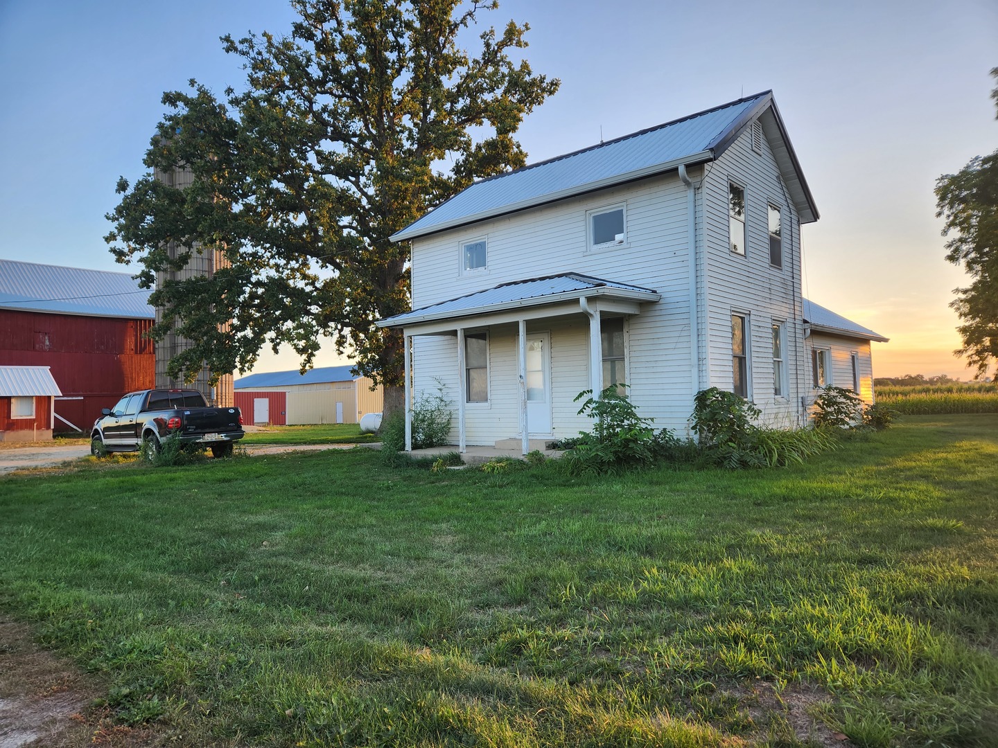 23909 Lawrence Road Harvard, IL 60033 - Photo 6 of 21 a view of a yard in front of a house with plants and large tree