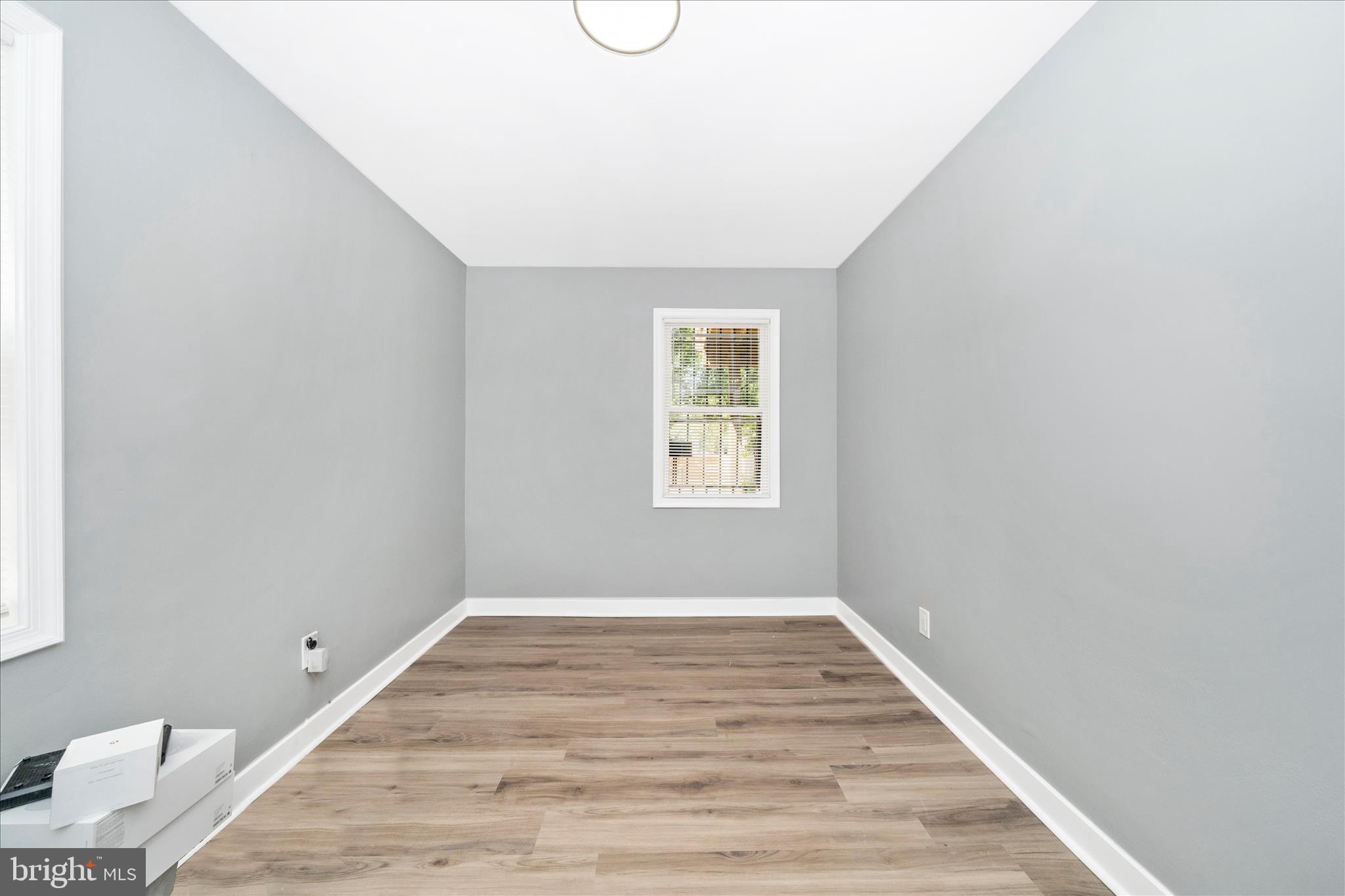 5027 Benning Road Southeast Washington, DC 20019 - Photo 28 of 57 a view of an empty room with wooden floor and a window