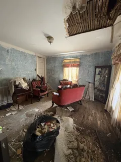 a view of a hallway and a livingroom with furniture