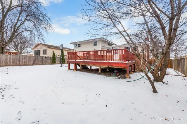 a view of a house with wooden fence