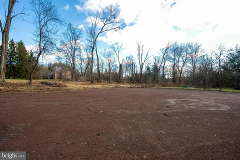a view of dirt field with trees
