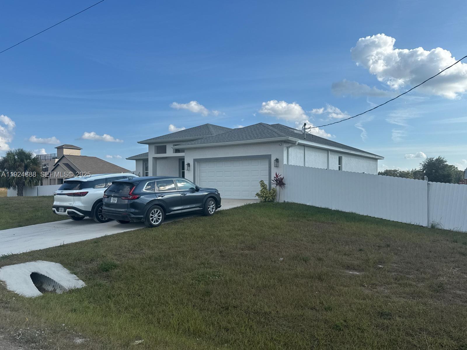 7799 16th Place LaBelle, FL 33935 - Photo 5 of 9 a front view of a house with a garden and parking space