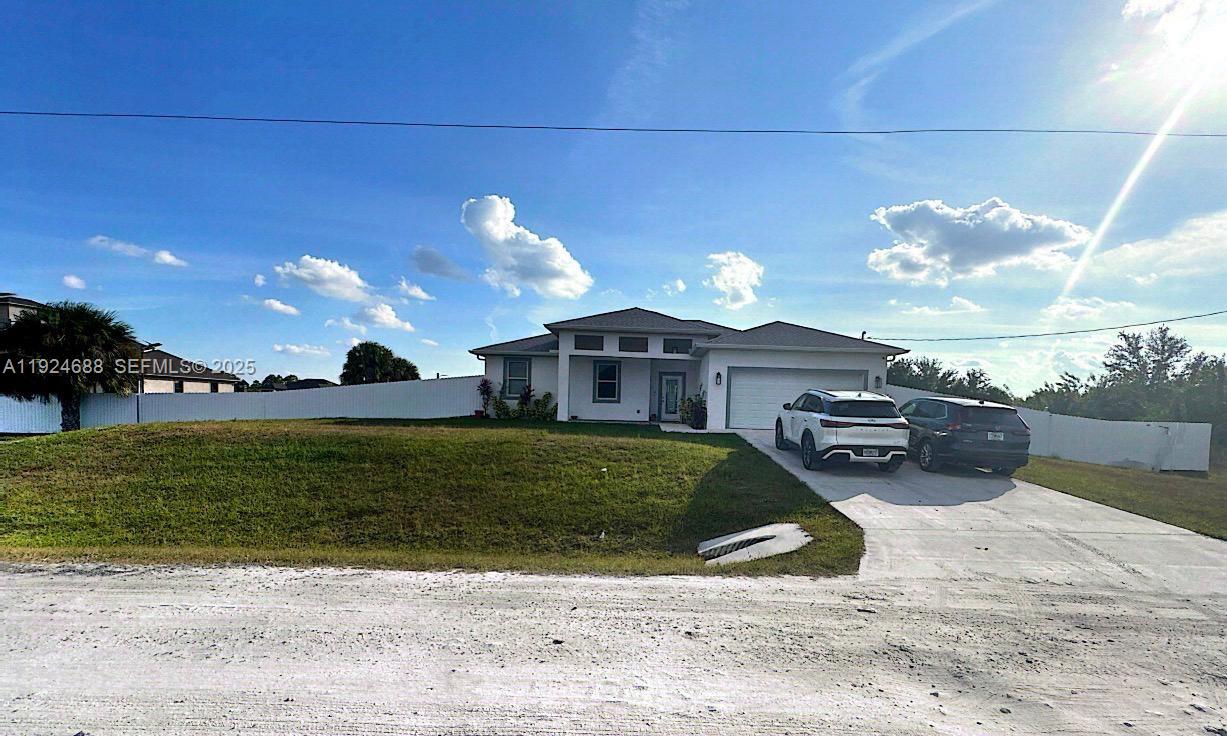 7799 16th Place LaBelle, FL 33935 - Photo 8 of 9 a view of a house with a yard