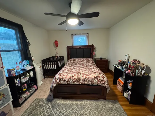 a bedroom with bed and a chandelier