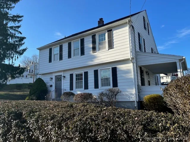 a front view of house with a garden