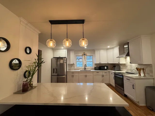 a kitchen with cabinets and stainless steel appliances