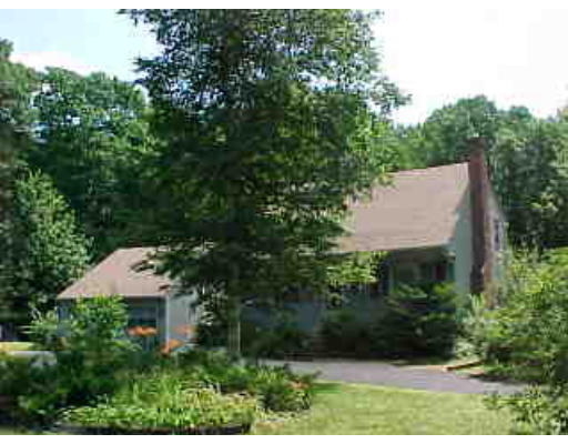 an aerial view of a house with yard and outdoor seating