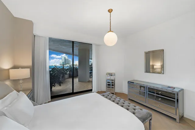 a balcony with furniture and a potted plant